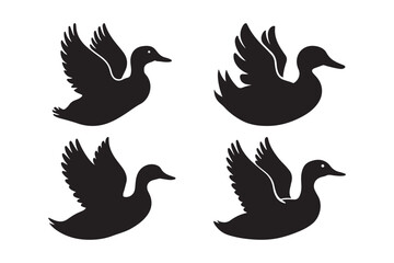 Fototapeta premium Four silhouettes of ducks in flight