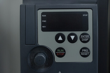 Control panel featuring buttons for operation and adjustments in a machinery setup