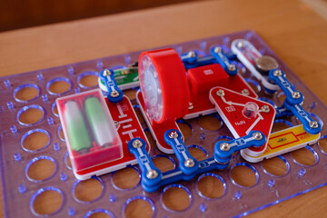 Creative hands-on learning with an electronic circuit kit showcasing vibrant components and a light