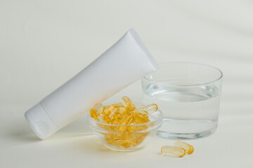 Skincare cream, capsules, and water promoting healthy lifestyle