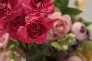 Selective soft focus Red Rose Flower bouquet, green leaf foliage. Natural blur background.