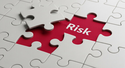 White puzzle pieces surround a red piece with the word "Risk" This symbolizes challenge, problem-solving, and strategic thinking