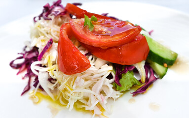 fresh prepared salad on a white plate, organic and vegetarian food theme