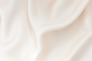 Soft cream fabric draped elegantly highlighting smooth texture and gentle folds in natural light