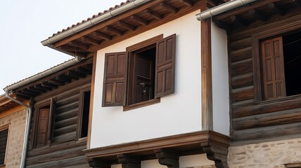 Charming old wooden building with open shutters on a sunny day