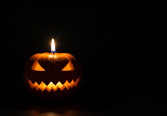 Minimalist Black Background with Single Glowing Pumpkin Candle