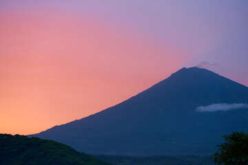 Silhouette of the Agung volcano at sunset. Panorama of the mountain on the island of Bali.