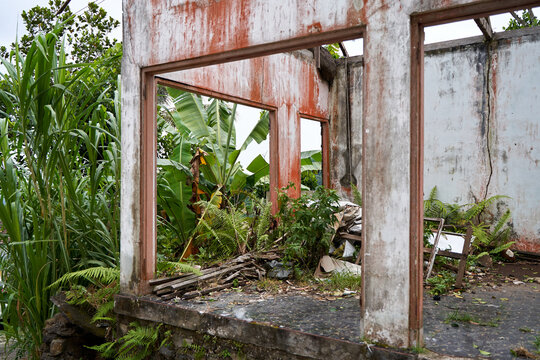 Walls from an abandoned old ruined house without a roof after a catastrophe.