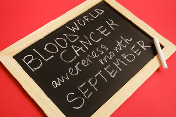 blood cancer concept, blood cancer awareness month, chalk writing on black board, red background