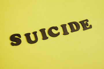 stop suicide concept, inscription made of wooden letters on a bright background