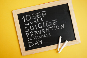 suicide inscription "September suicide prevention month" in chalk on a black chalk board