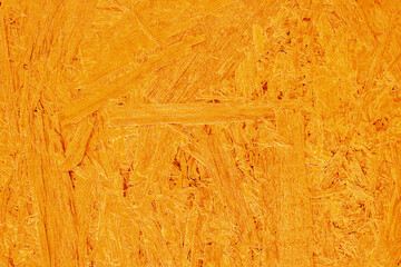 Orange fiberboard background wood processing waste texture pressed wood bright