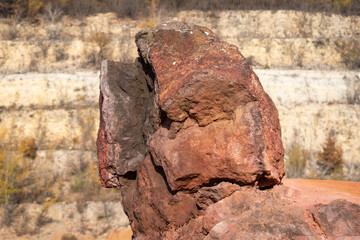 Eroded bauxite rock formation with bright orange colors in an abandoned bauxite mine