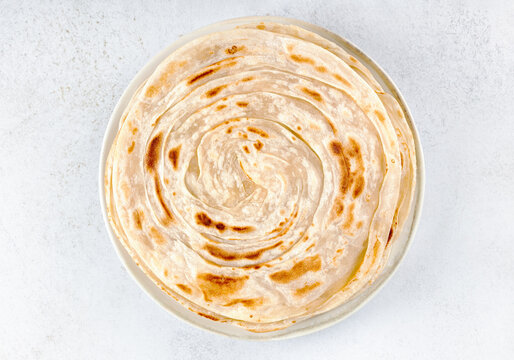 Traditional Indian paratha on white background. Indian food. Top view. Close up