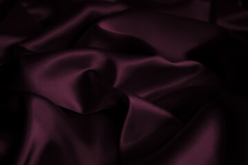 Wine hue, grape purple, raisin violet, plum, blackberry, dark magenta trendy passionate bright intense elegant color. Silk satin wrinkled crumpled texture background with folds. Underwear sleek fabric