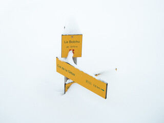 Waymark guide post buried in snow in the French Alps