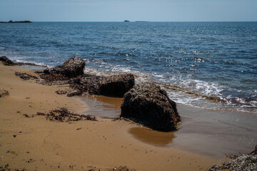 Beautiful seascape with rocks, sea waves and blue sky on Korfu Greece