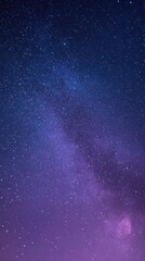 Obraz premium A breathtaking view of the milky way galaxy stretching across a deep blue and purple night sky, filled with countless stars and nebulae
