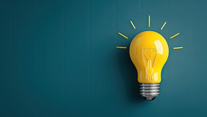Bright yellow lightbulb on teal background