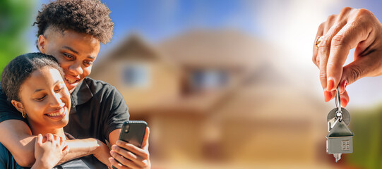 young couple with a phone looking to buy a house online