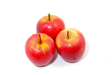Fresh red apples together on white background close up view