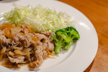 Japanese dinner with pork ginger stir fry and shredded cabbage
