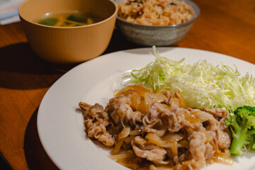 Japanese dinner with pork ginger stir fry and shredded cabbage
