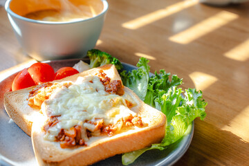 Breakfast with cheese toast and vegetables
