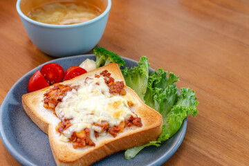 Breakfast with cheese toast and vegetables
