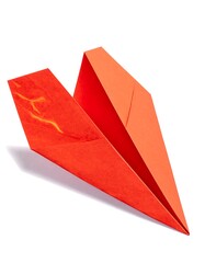 A vibrant red paper airplane, angled against a plain white backdrop, displays intricate folds and subtle textures.