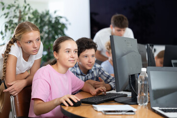 Group of children students learn to work with computer at lesson