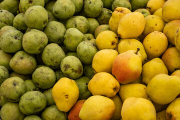 green and yellow pears at the market, top view