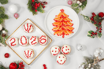 Christmas and New Year dishes. Curd muffins with pomegranates in glaze with numbers 2026 and a Christmas tree made of tangerines for a festive table, an idea for decorating food