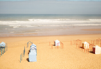 Striped beach tents on golden sand in Santa Cruz, Torres Vedras, Portugal. 10 September 2025