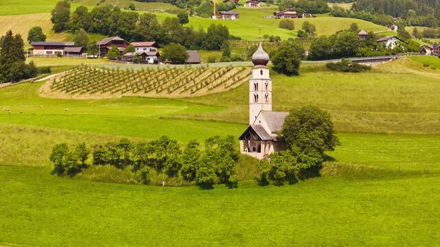 Church of Saint Valentine on Seiser Alm, Dolomites, aerial view. Historic rural parish within South Tyrol countryside