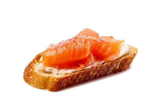 Salmon and cream cheese sandwich or canape with grain bread on white background