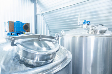 Modern industrial beer factory with large stainless steel brewing tanks