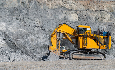 Heavy-Duty Excavator Mining Operations in Rugged Quarry Environment, open pit mine industry.