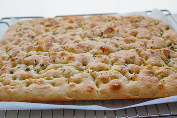 Homemade herb-infused focaccia made in Italian homes