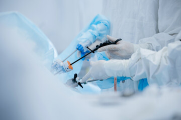 Surgical team performing laparoscopic procedure in operating room