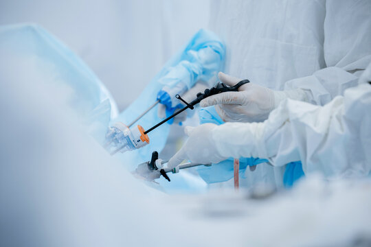Surgical team performing laparoscopic procedure in operating room
