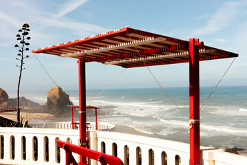 Red bench with ocean view in Santa Cruz, Torres Vedras, Portugal. 10 September 2025