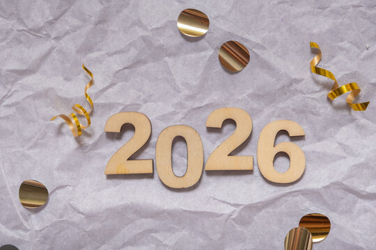 Celebration of the New Year 2026 with festive decorations and confetti on a textured background