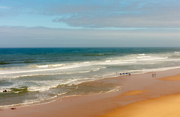 Santa Cruz, Torres Vedras, Portugal. 10 September 2025. Wide sandy beach with ocean waves under clear blue sky.