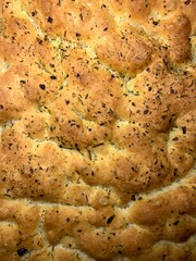 Focaccia with Italian herbs and tomatoes. Homemade bread. Yeast pastries. 
