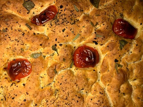 Focaccia with Italian herbs and tomatoes. Homemade bread. Yeast pastries.  - Powered by Adobe