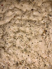 Yeast dough. Focaccia with Italian herbs and tomatoes. Homemade bread. Yeast pastries. 