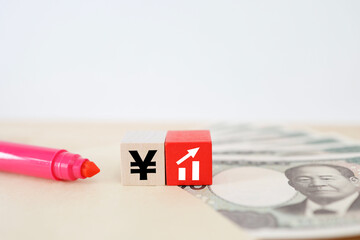 円高や日本株上昇を示す円記号とグラフ。