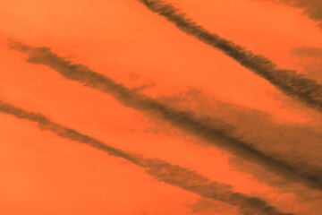 Traces airplane air trail jet line stripe sunset orange sky background