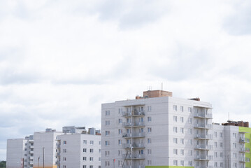Fototapeta premium The ongoing development of modern buildings at the construction site is a vital task in progress. A construction site showcasing the ongoing development of modern residential buildings and facilities